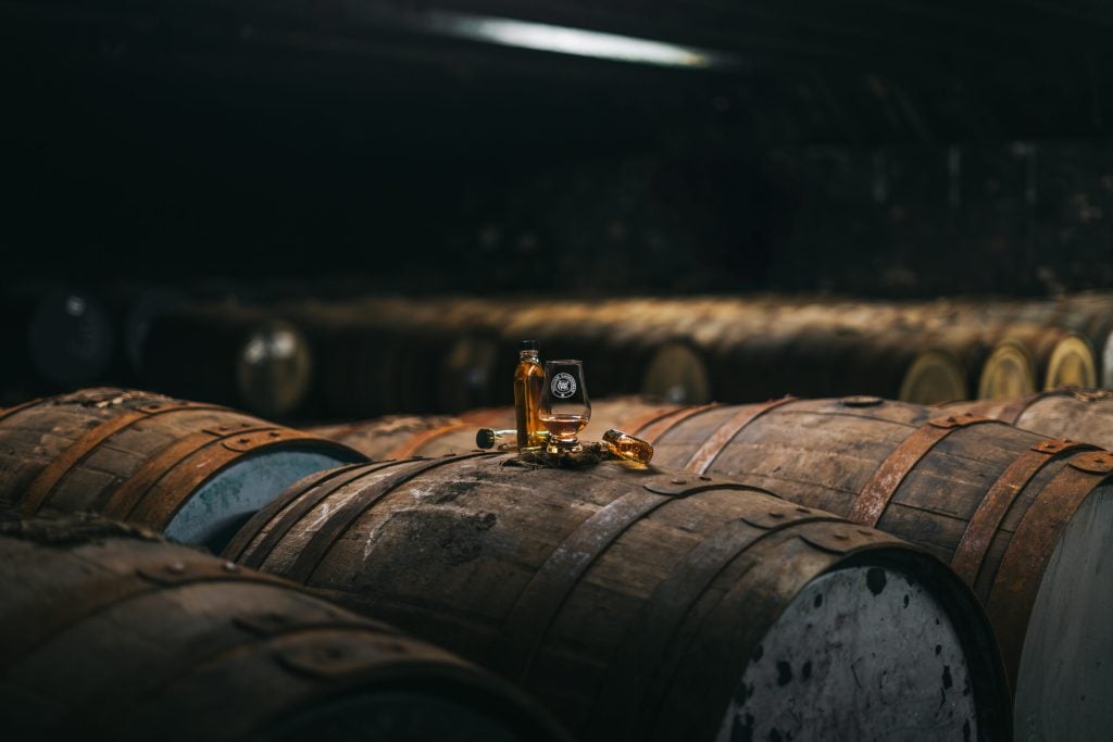 A Glencairn glass resting on a cask in the Cadenhead's warehouse