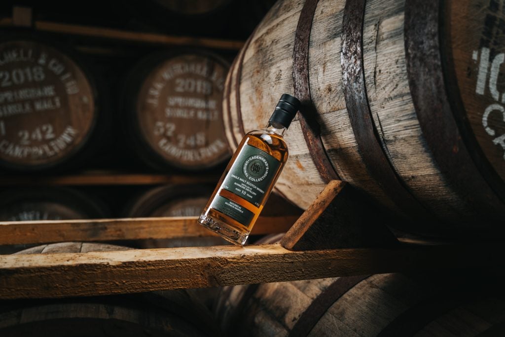 A Cadenhead's bottling resting on a cask in the warehouse