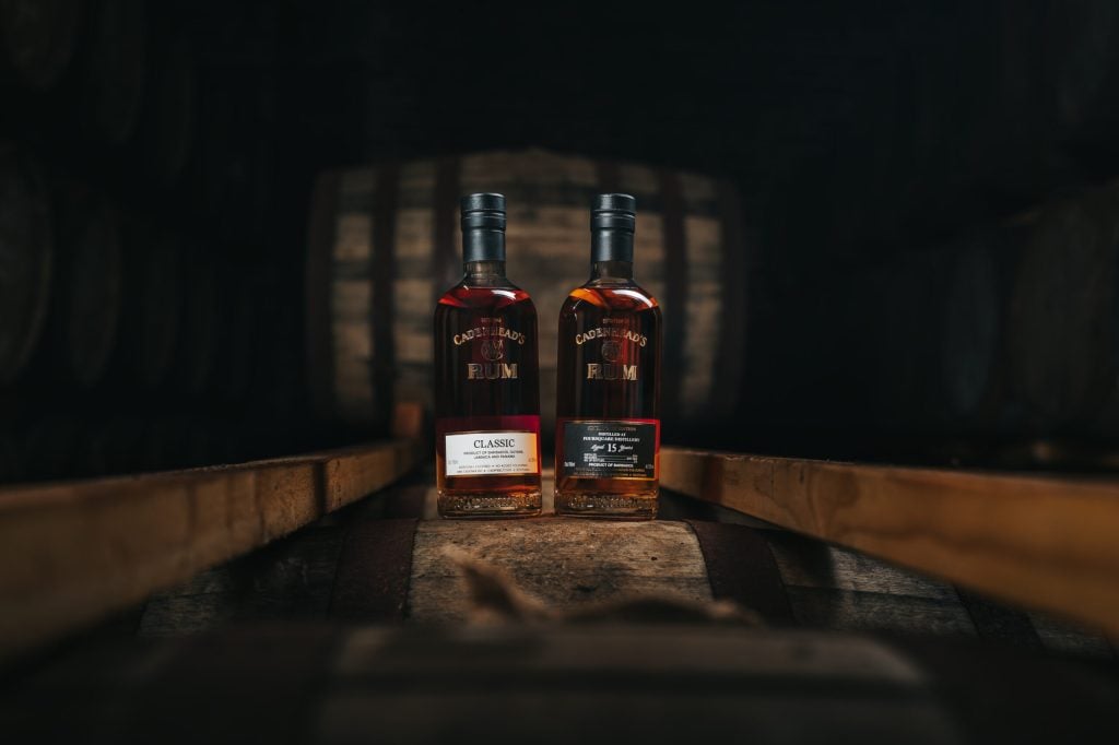 Cadenhead's rum bottles on casks in the warehouse